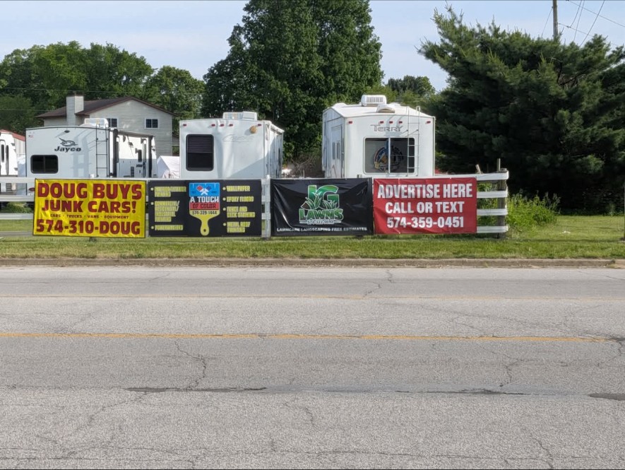Row of local business banners along the roadside at CR 6 & CR 10 in Elkhart